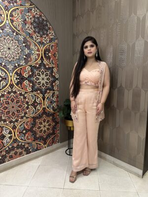 Peach jacket with embroidered bustier teamed up with pants